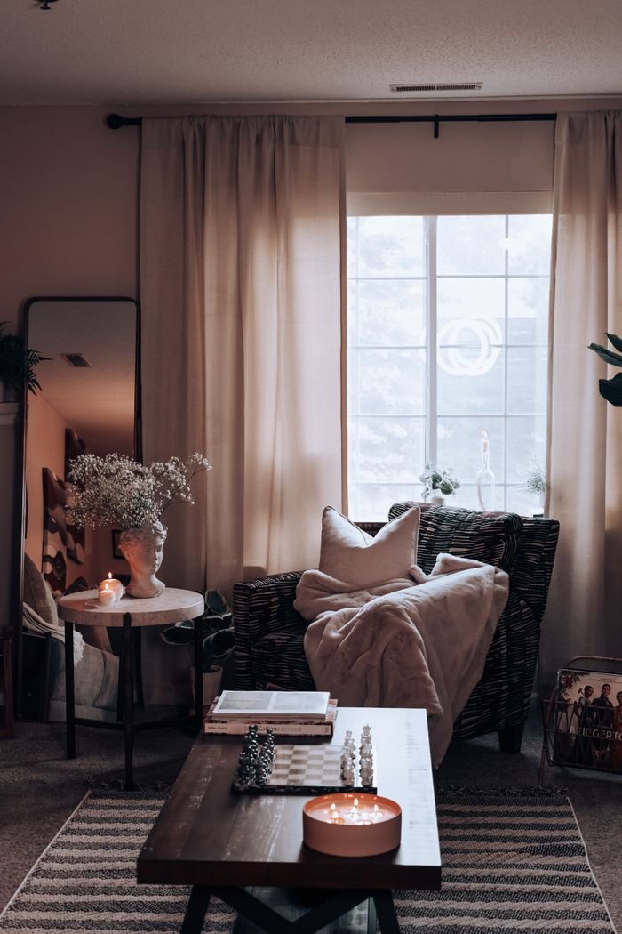 The Art of Drawing Readers In: Your attractive post title goes here A stylish and cozy living room interior with warm lighting, featuring a wicker armchair and decorative elements.