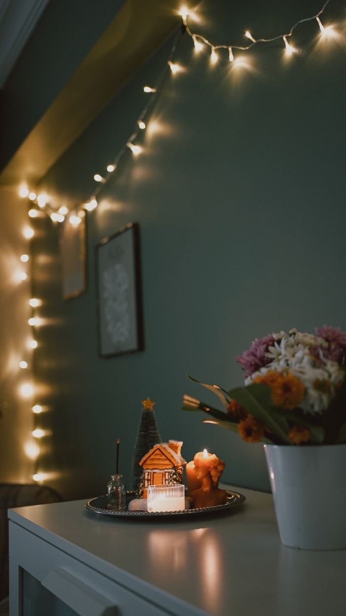 Crafting Captivating Headlines: Your awesome post title goes here Warm and cozy indoor Christmas decor with fairy lights and gingerbread house.