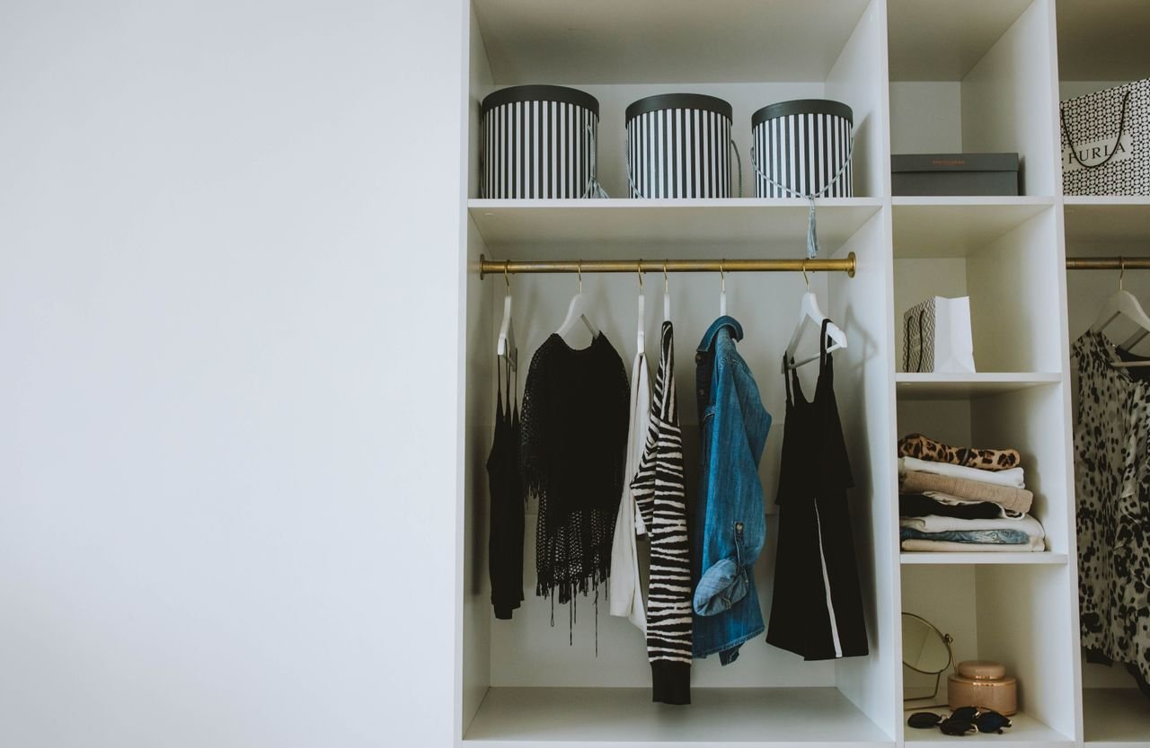 Mastering the First Impression: Your intriguing post title goes here Organized wardrobe with trendy clothes, hangers, and storage boxes.